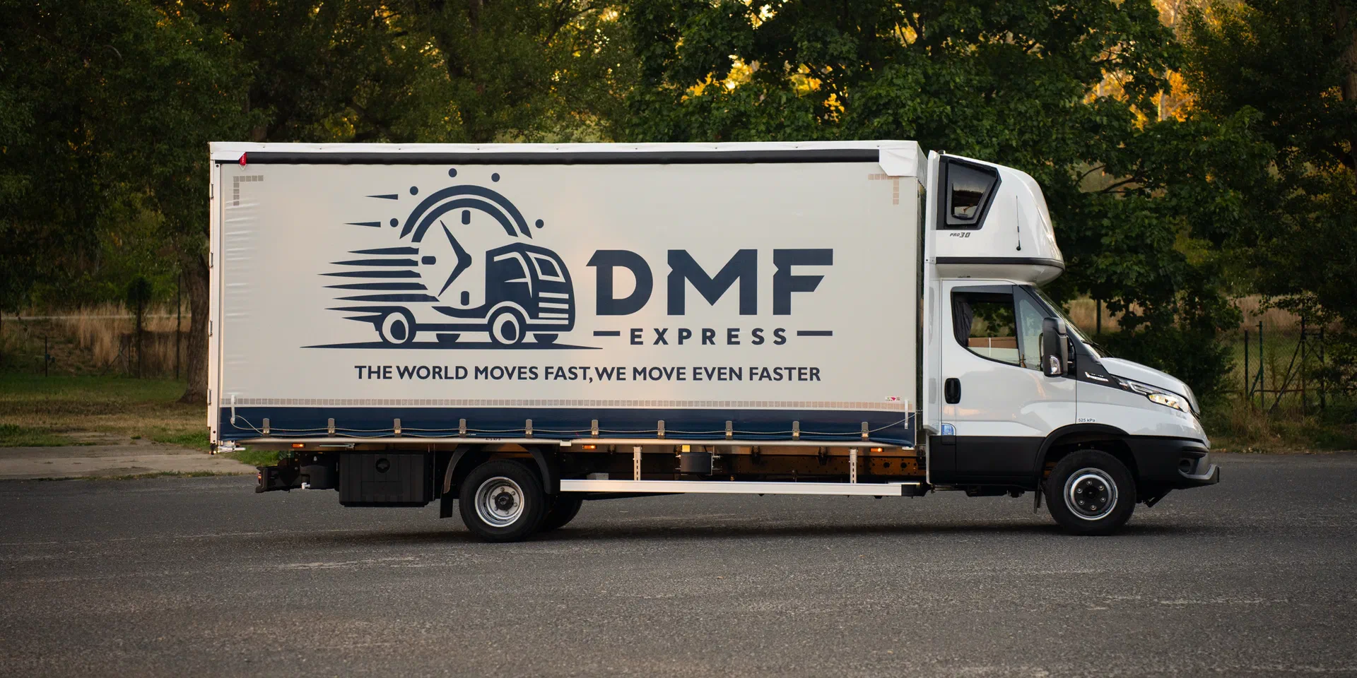 DMF Express 7.2 t Iveco Daily curtain-side truck seen from the side, showing the full tautliner body