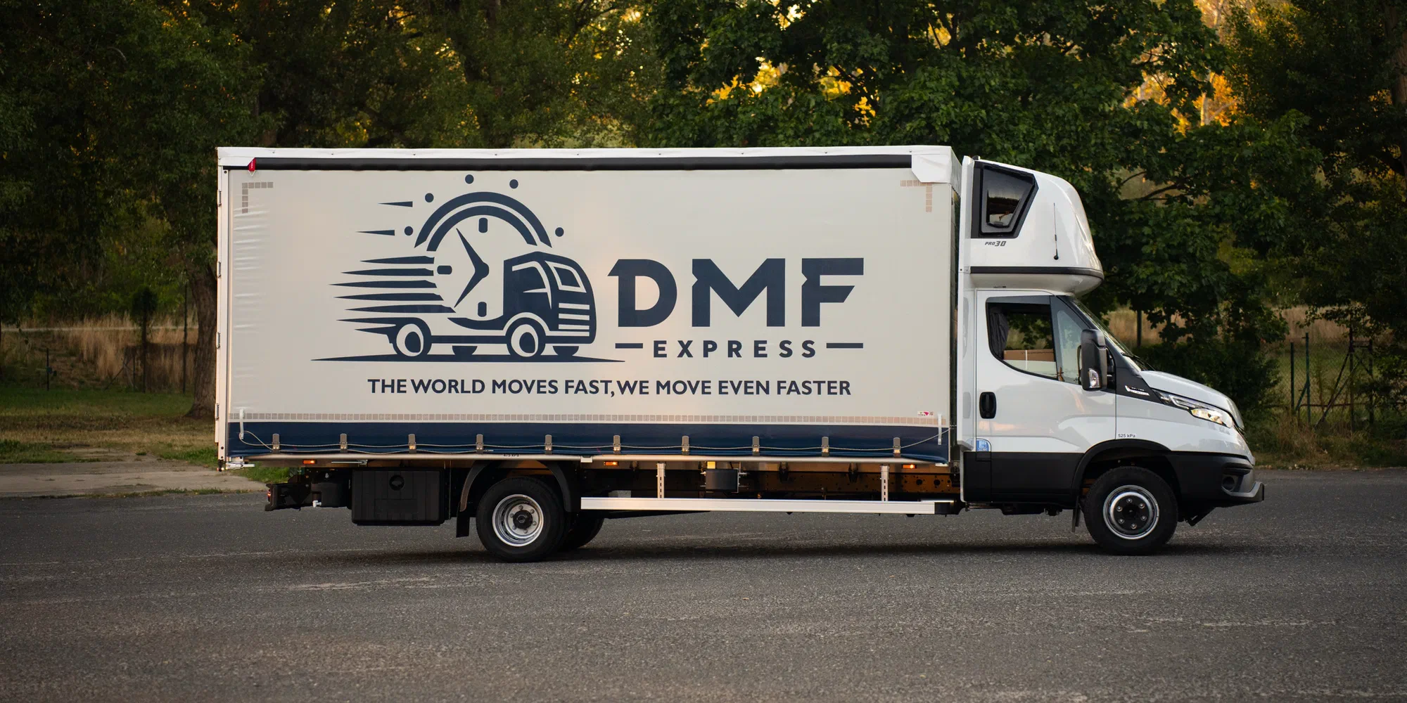 DMF Express 7.2 t Iveco Daily curtain-side truck photographed from the side, showing the full tautliner body