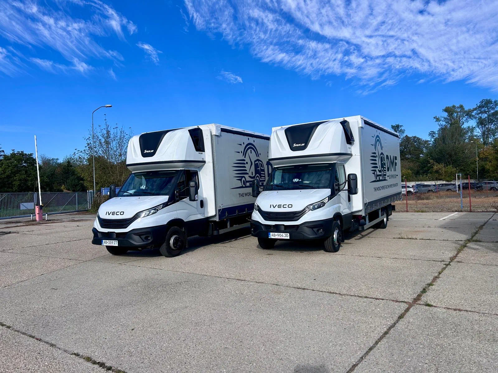 Two DMF Express 7.2 t Iveco Daily curtain-side trucks parked side by side